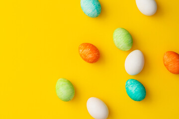 Hand painted colorful easter eggs on yellow background.