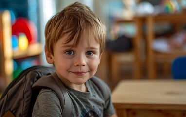 Little Boy Sitting at Table With Backpack On