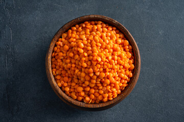 Uncooked lentils on black background