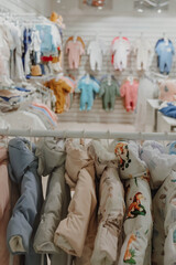 Children's spring jumpsuits hang on a hanger at a children's clothing store