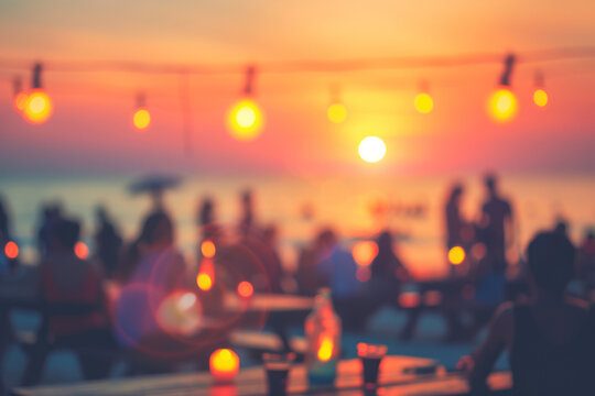 Blurred people having sunset beach party in summer vacation.
