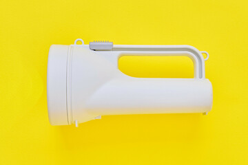 Safety flashlight on yellow background.