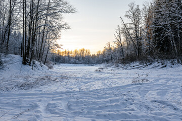 winter landscape on a pond. beautiful winter sunset. snowy nature landscape