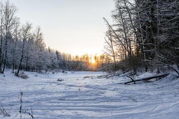 winter landscape on a pond. beautiful winter sunset. snowy nature landscape