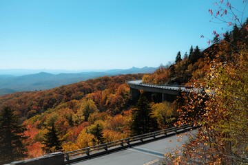 Scenic view of a long highway snaking through a hillside during the fall at the Linn Cove Viaduct
