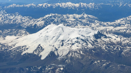 Fototapeta na wymiar Aerial view of snow-covered Elbrus. The highest mountain peak in Russia. The Caucasus Mountains.