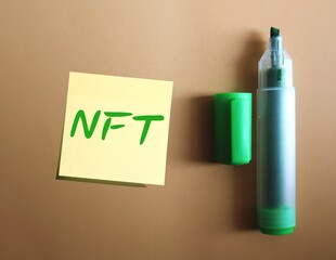 Green highlight pen with handwritten stick note NFT - (Non-fungible token) digital object like drawing, animation, music, photo, video with certificate of authenticity created by blockchain technology