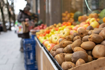 Kiwis and fruits in the window of a vegetable store