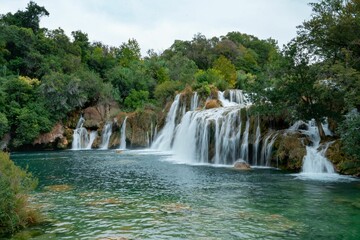 Fototapeta na wymiar Aerial view of a majestic waterfall cascading down a rocky cliff face: Croatia