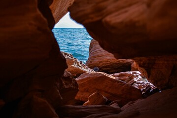Breathtaking view of the glistening Arabian Sea seen through rocky caves in the United Arab Emirates