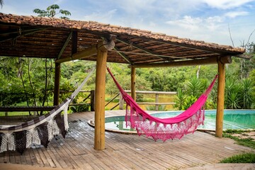 the hammock has been up in the trees near a swimming pool