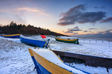 Fishing boats on the Baltic Sea beach in Jantar at winter. Poland