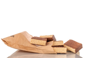 Several sweet chocolate wafers with paper bag, macro, isolated on white background.