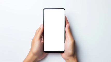 Close-up of hands holding smartphone with blank white screen on blank background