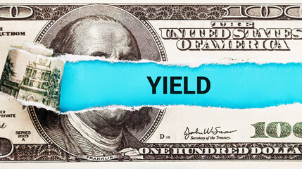 Yield. The word Yield in the background of the US dollar. Investment Return, Dividend, and Interest...