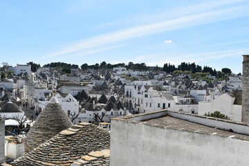 a white rooftop with a lot of small buildings and chimneys