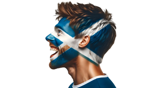 man soccer fun profile portrait with painted face of scottish national flag isolated on transparent background