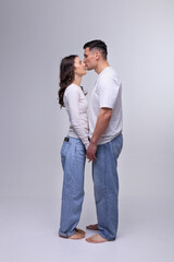 Fototapeta premium This captivating minimalist portrait features a couple in a quiet embrace, bathed in soft light.