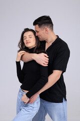 This captivating minimalist portrait features a couple in a quiet embrace, bathed in soft light.