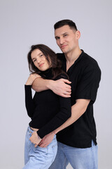 Fototapeta premium This captivating minimalist portrait features a couple in a quiet embrace, bathed in soft light.