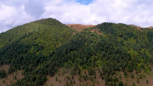 Aerial of big mountains under the cloudy sky during the daytime