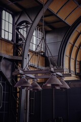 Vertical of a metallic, vintage chandelier hanging from a ceiling in a train station
