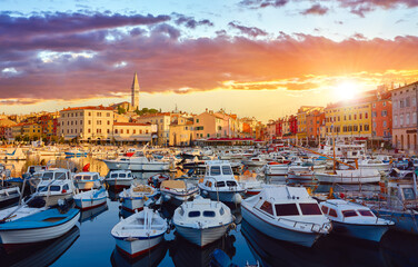 Rovinj, Istria, Croatia. Motorboats and boats on water in port Rovigno. Medieval vintage houses of...