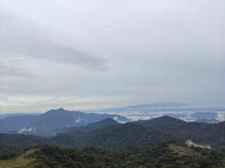 Aerial view of a green mountain range on a cloudy day