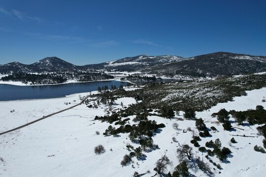Aerial view of a wintery landscape with snow-capped mountains in Julian,CA