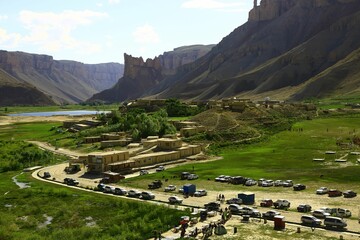 Picturesque view of a mountainous valley landscape of a winding road with cars parked along it