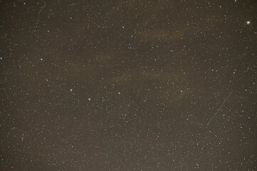 a very wide shot of a sky full of stars and clouds