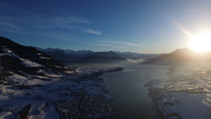 Fototapeta premium the sun shines on the surrounding mountains and glaciers as seen from the sky