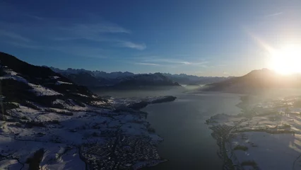 Gordijnen the sun shines on the surrounding mountains and glaciers as seen from the sky © Wirestock