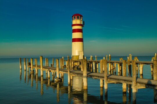 Lighthouse standing in the distance on the shores of Lake Neusiedl in Podersdorf, Austria.