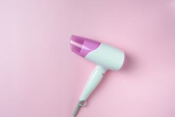 White hairdryer on a pink background. Top view, Flatley