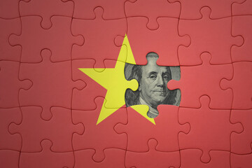 puzzle with the national flag of vietnam and usa dollar banknote. finance concept