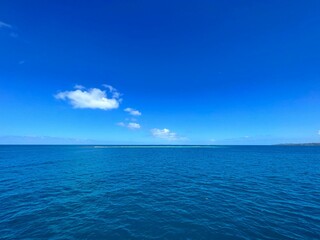 Fototapeta premium Stunning aerial shot of a tranquil lake and a blue sky with wispy clouds in the distance