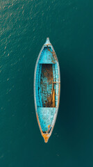 Top view of a retro fishing boat in blue clear ocean. Shade from the sun's rays. Ocean still life...