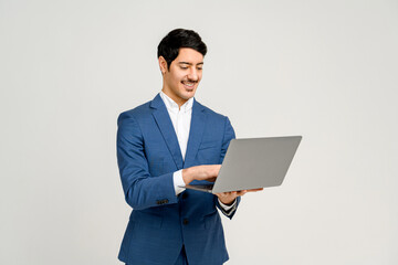 Content businessman engages with laptop, his expression one of satisfaction at the information or results displayed on the screen, perfect for themes of technology, business analytics, or remote work