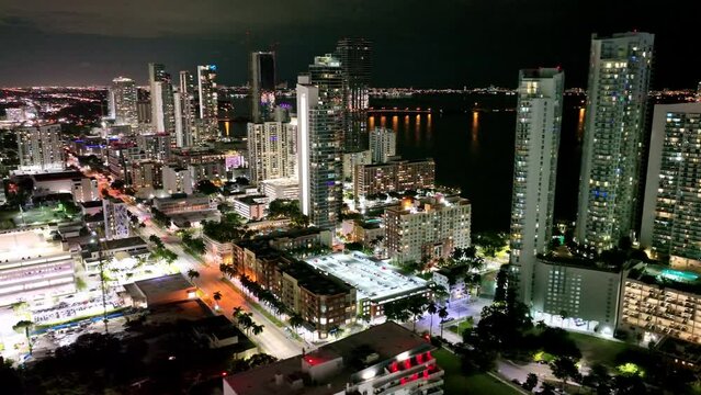 Aerial shot of illuminating Miami downtown Financial district and traffic on streets at night