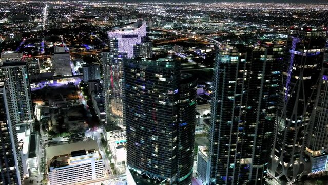 Aerial footage of high colorful Miami downtown skyscrapers and street traffic at night