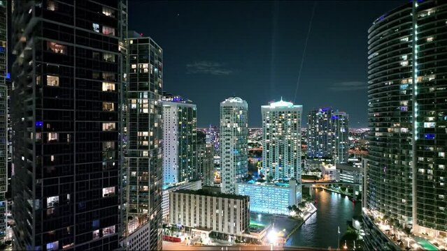 Drone footage of high colorful Miami downtown skyscrapers and street traffic at night