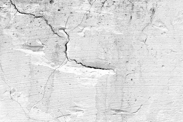 Dirty old cracked white painted concrete wall. Uneven grunge and rough cement surface wall. 