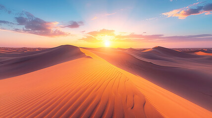 The sun dips below the horizon, casting a warm glow over smooth sand dunes in a vast desert landscape.
