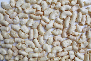 Fried macaroni crackers, on white background, flat lay or top view