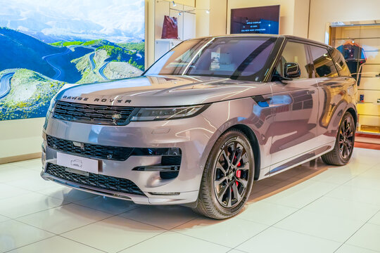 Land Range Rover silver gray in the showroom on the shop showcase exhibition of an official dealer. Thailand, Bangkok 21 december 2023