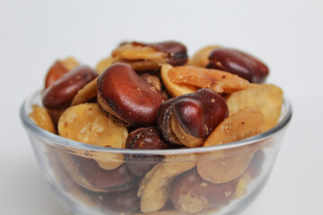 Kacang koro, or cooked jack bean, in a transparent glass bowl, isolated on white background