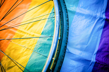 wheelchair next to colorful flag that has colors like blue, red, green and yellow, July, disability pride month