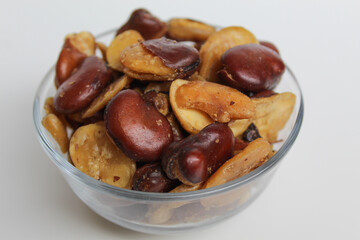 Kacang koro, or cooked jack bean, in a transparent glass bowl, isolated on white background