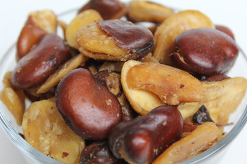 Kacang koro, or cooked jack bean, in a transparent glass bowl, isolated on white background